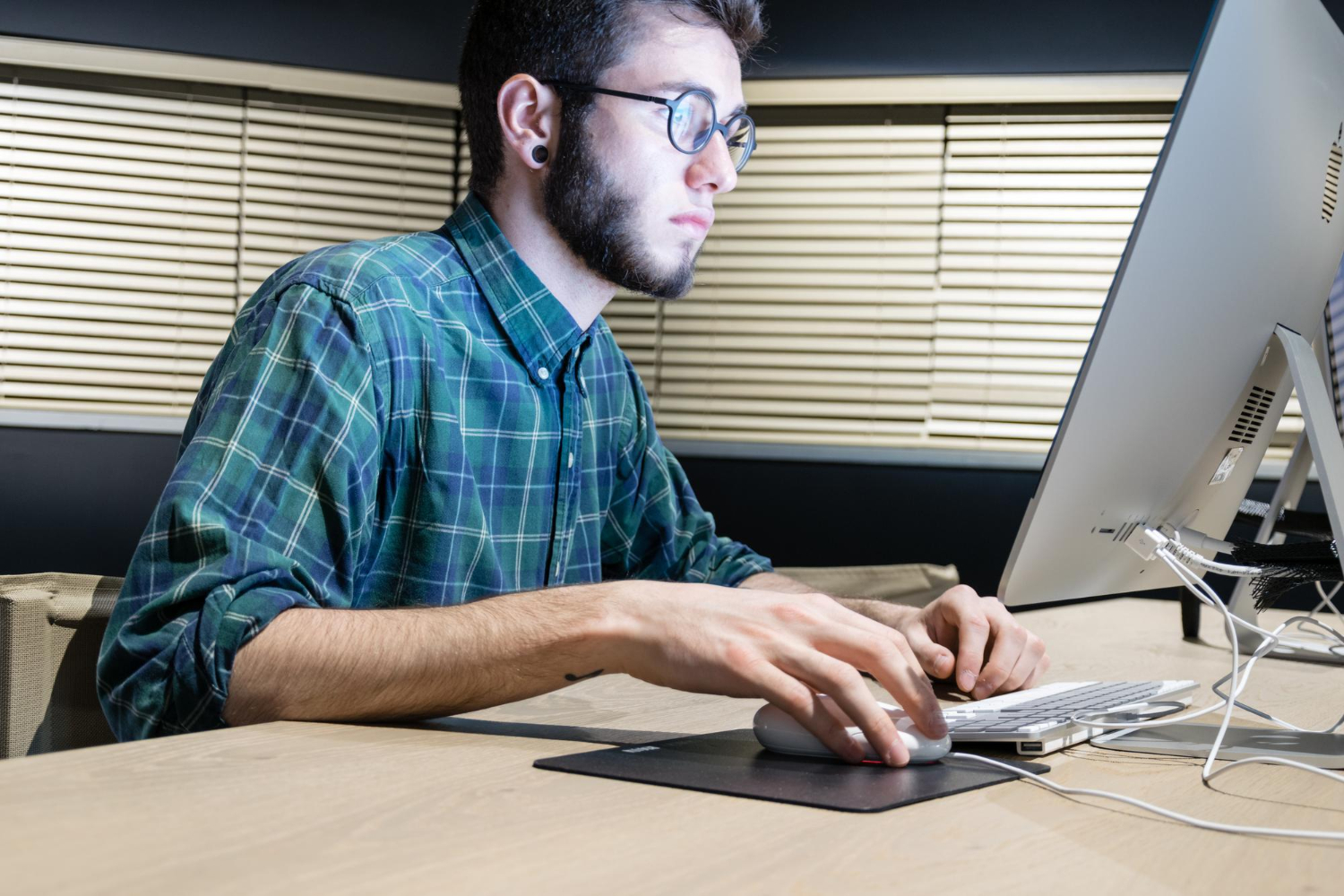 a guy with glasses using a computer